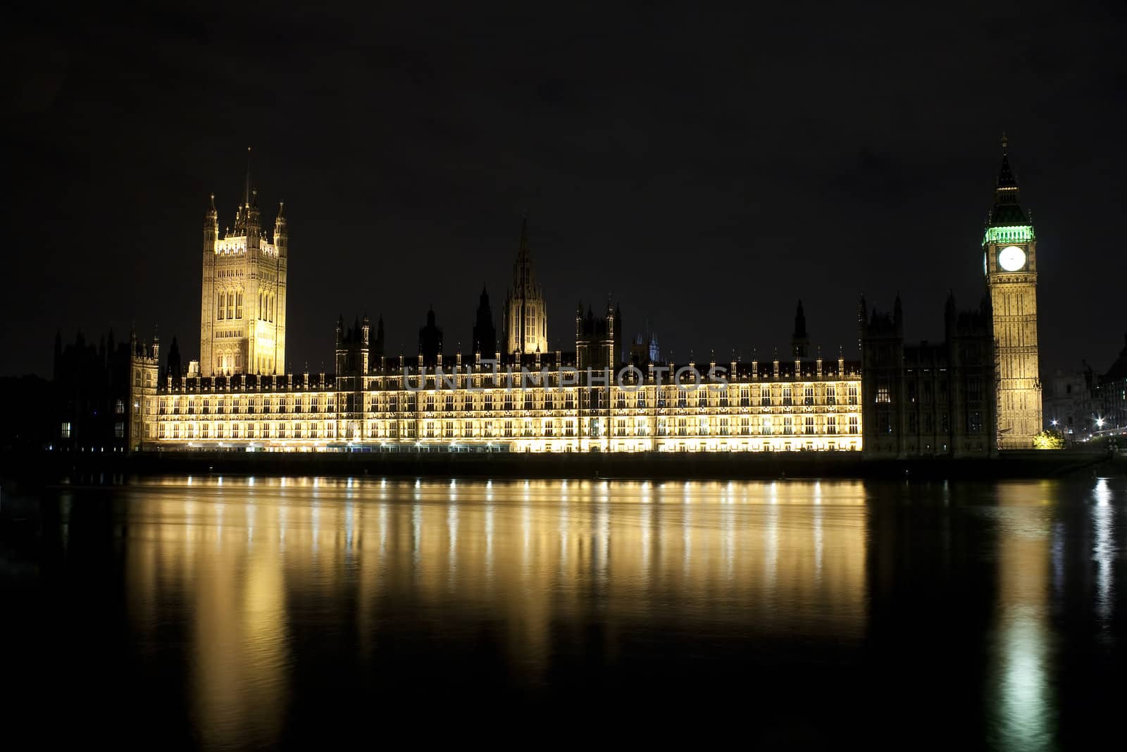 The Big Ben and the Parliament illuminated at night with reflections in the river