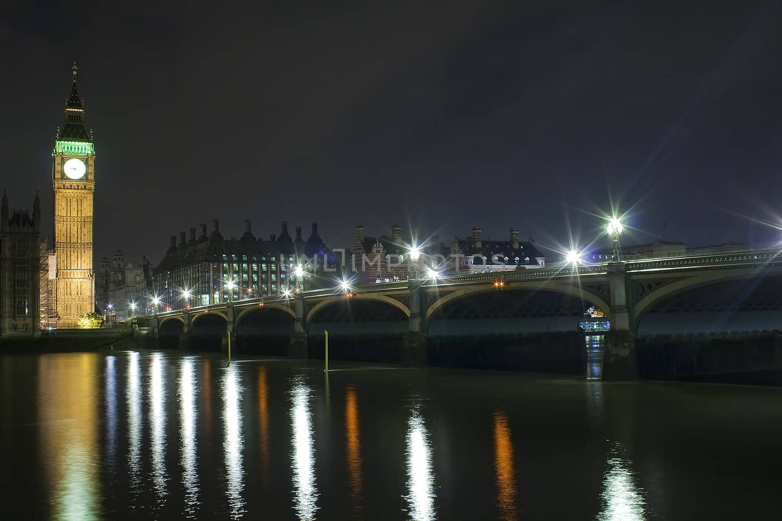 The Big Ben and Westminster Bridge at night with reflections in the river Thames