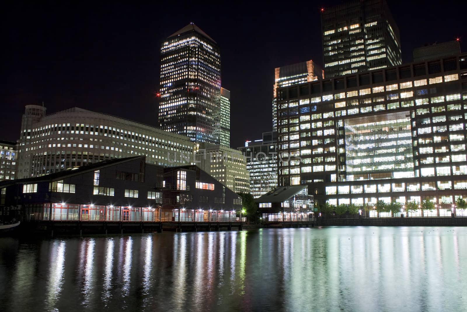 Canary Wharf skyscrapers in London at night by kmiragaya