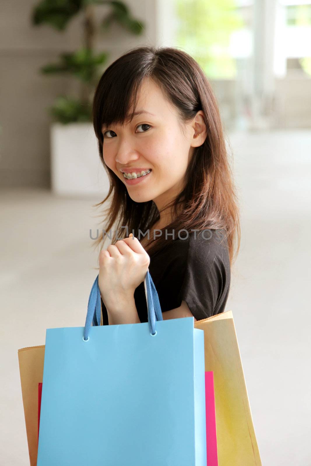Asian Teenager Female With Shopping Bags in Mall