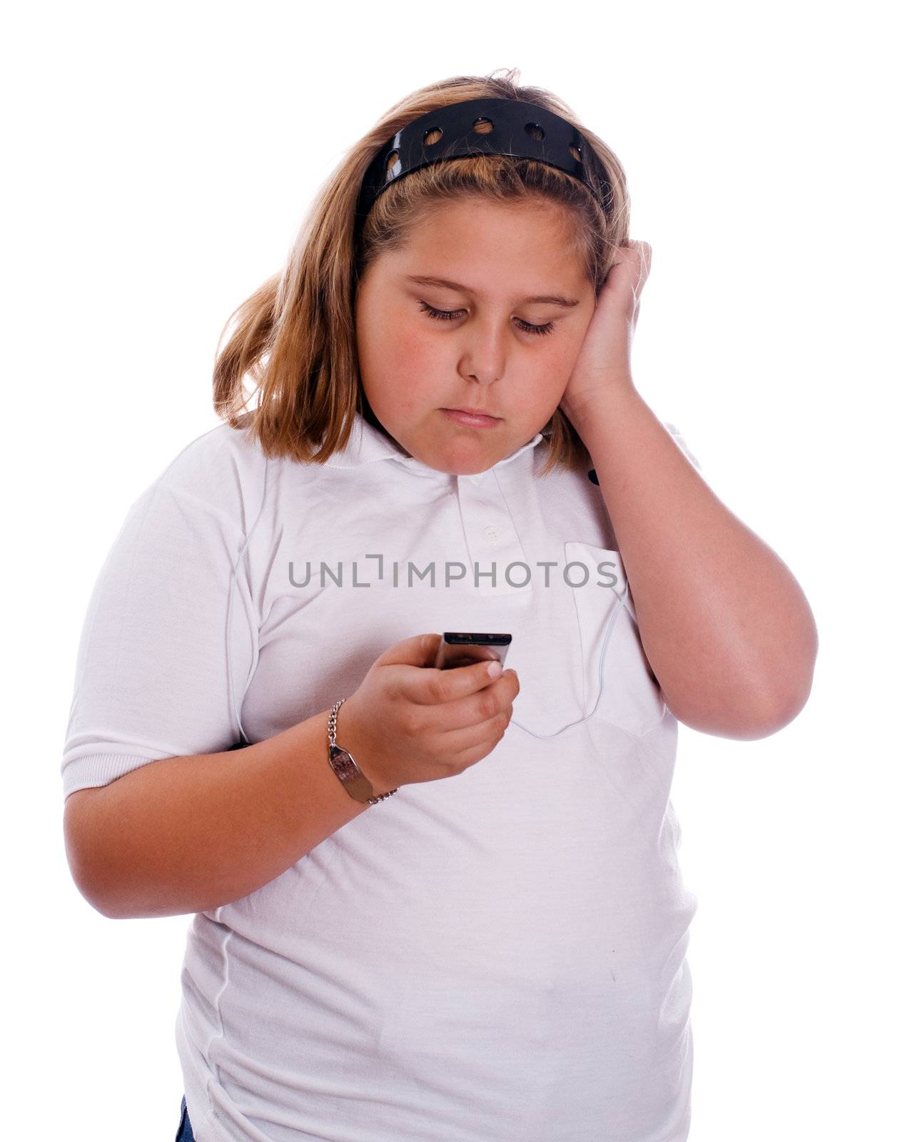 A young girl listening to her MP3 player isolated against a white background