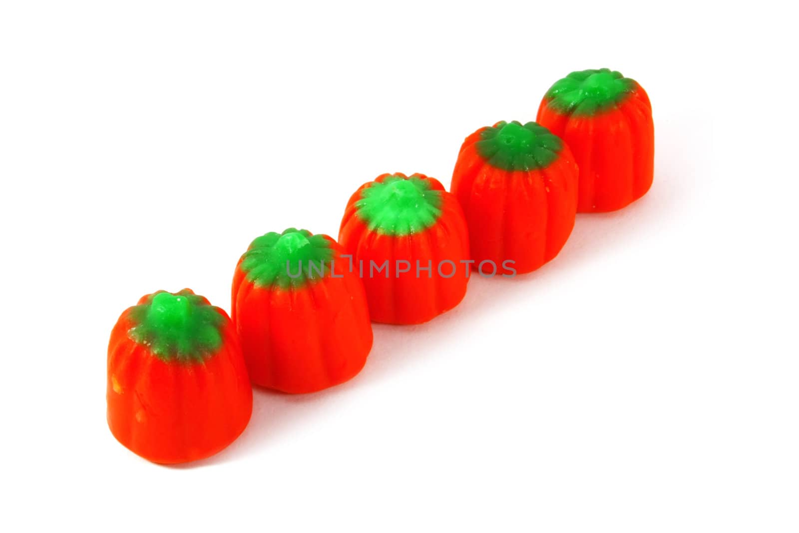 Row of Pumpkins Halloween Candy on a White Surface