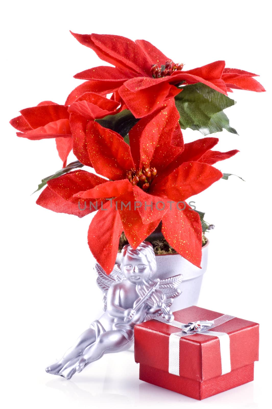 Red poinsettia, a silver angel and a red little christmas present, isolated on white.