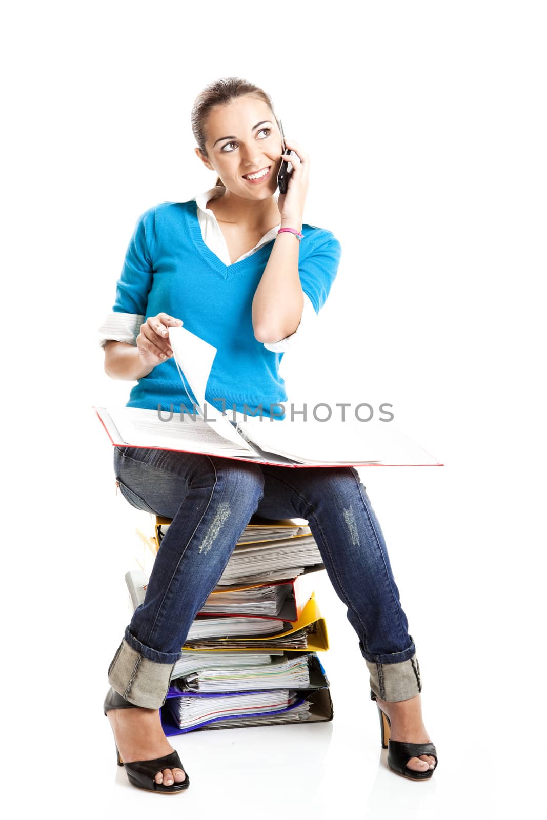 Beautiful female student making a phone call isolated on white