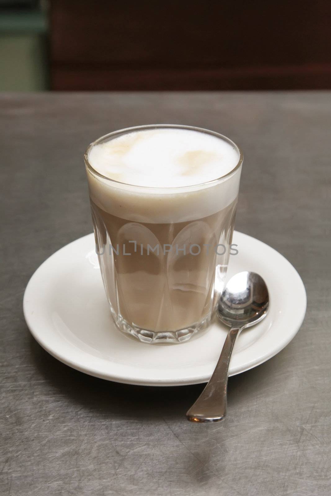 Cafe Latte Coffee on a Saucer with Teaspoon