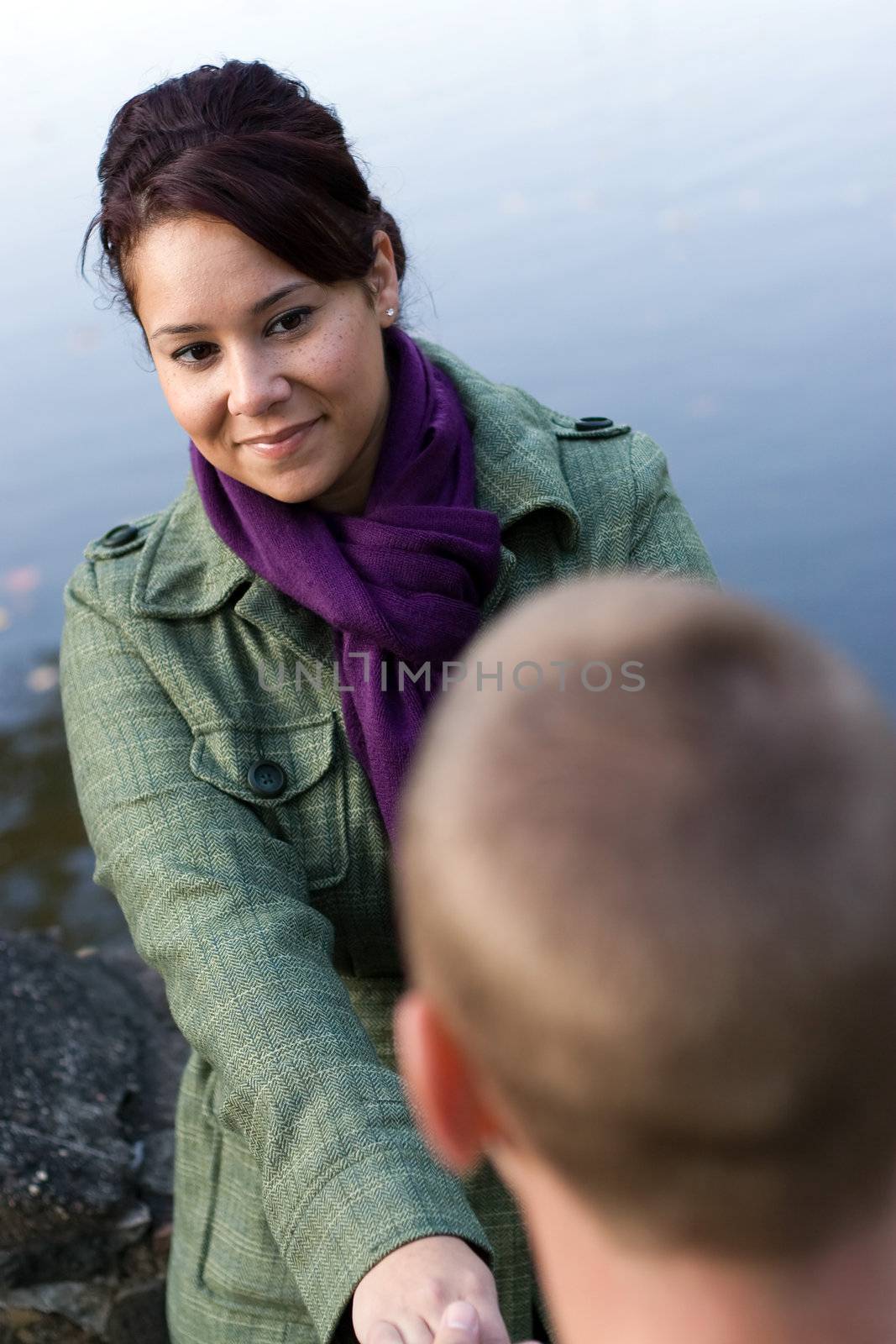 A young happy couple holding hands outdoors.