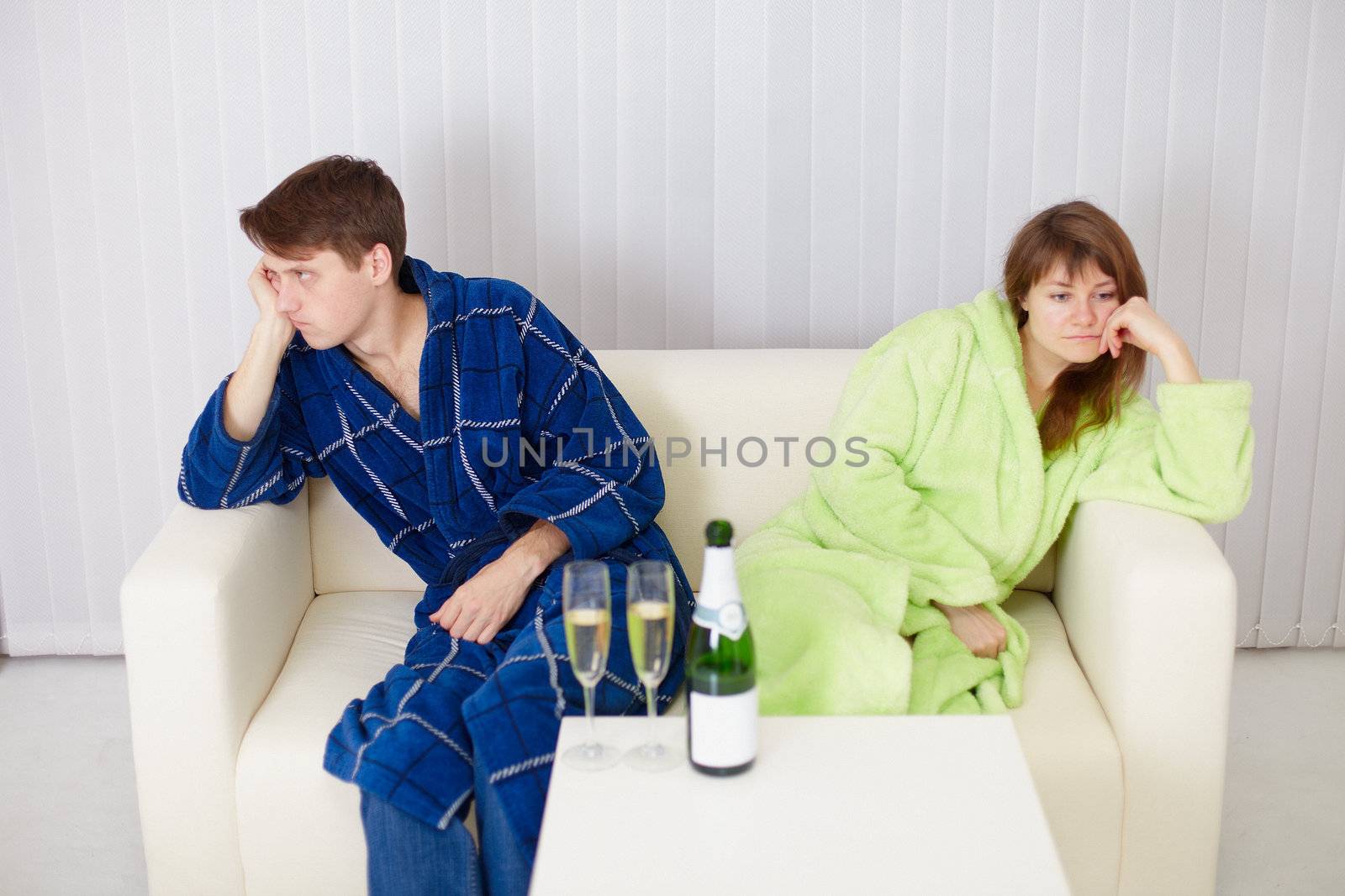 The quarrelled husband and the wife at the house on a sofa