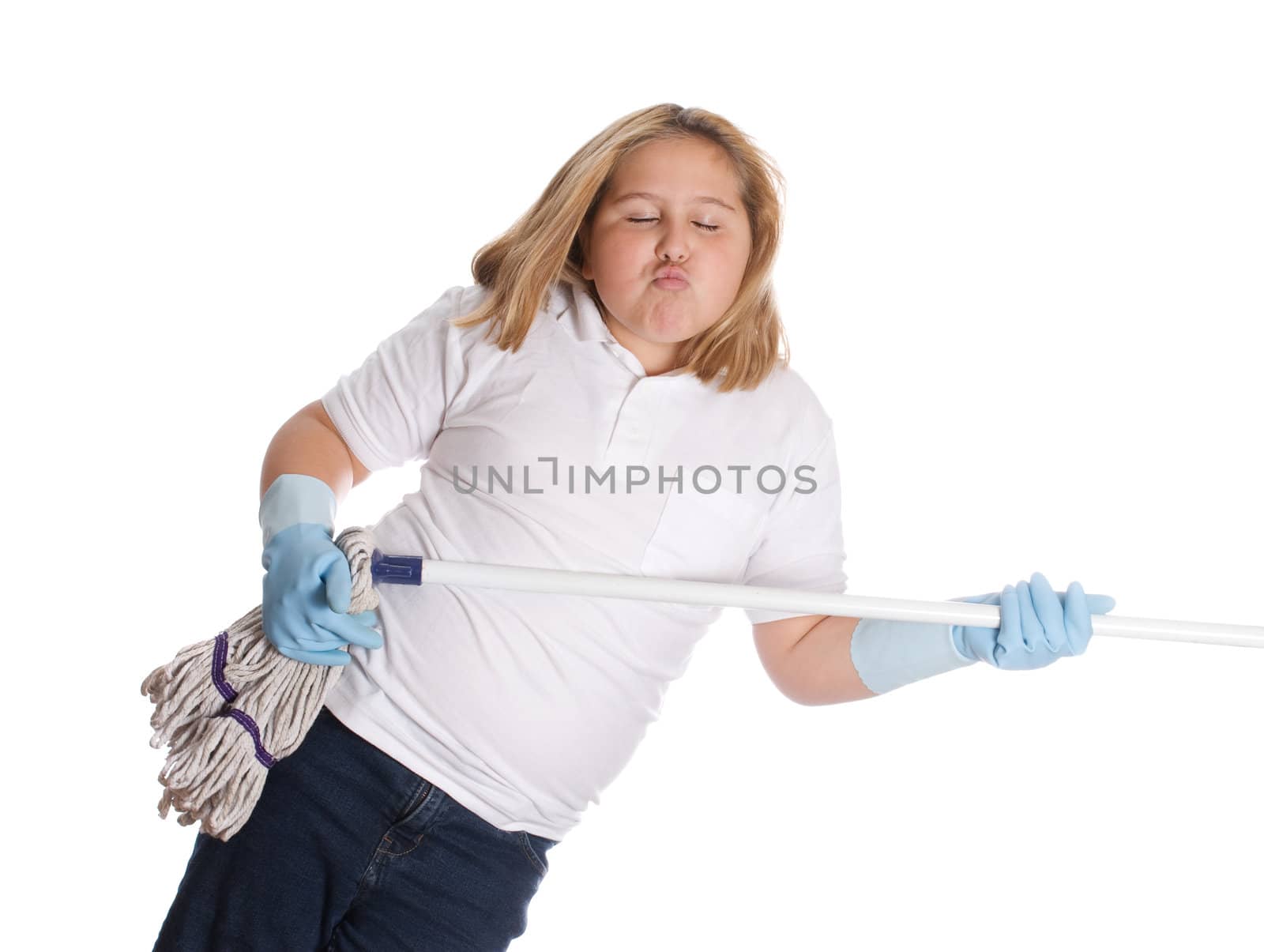 A young girl pretending to play the guitar on a mop, isolated against a white background