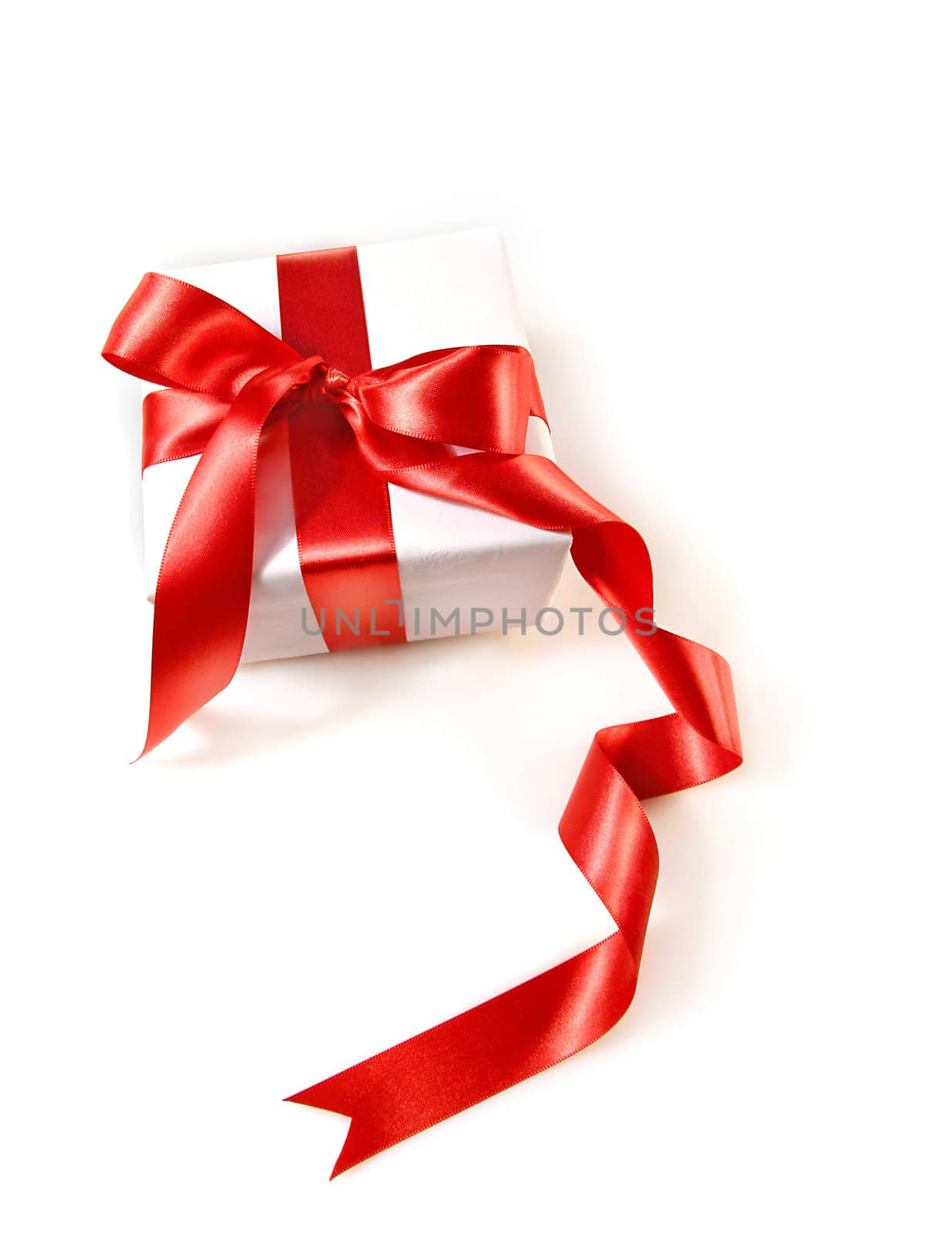 Gift box wrapped with red satin ribbon on white