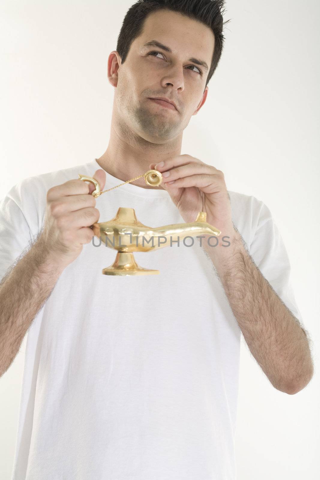 A young, caucasian male, holding a golden magic lamp.
