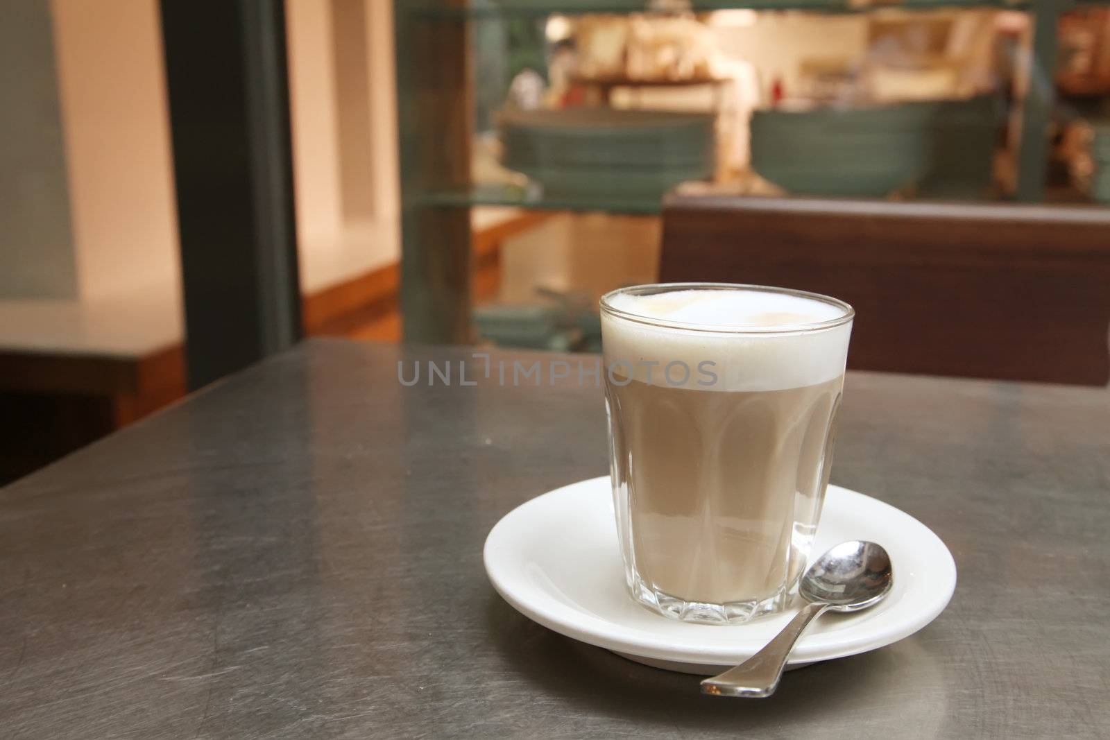 Cafe Latte Coffee on a Saucer with Teaspoon