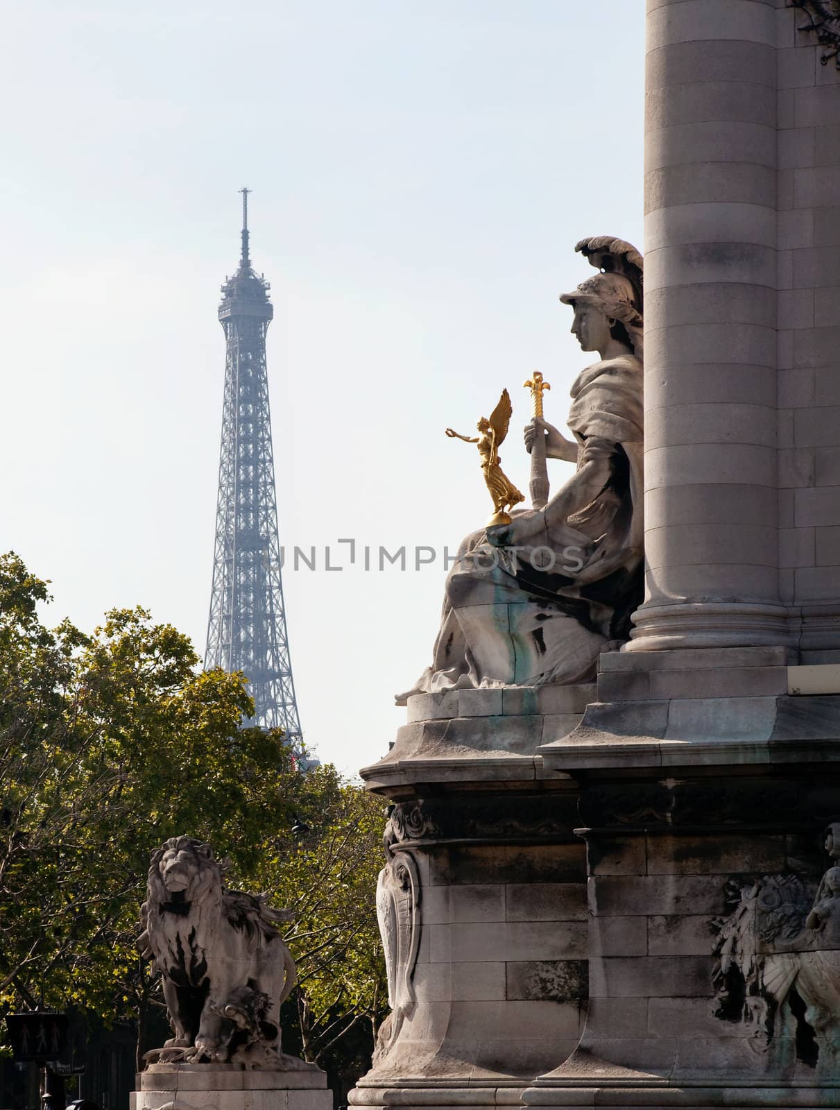Statue on Pont Alexandre frames a distant hazy shot of the Eiffel Tower