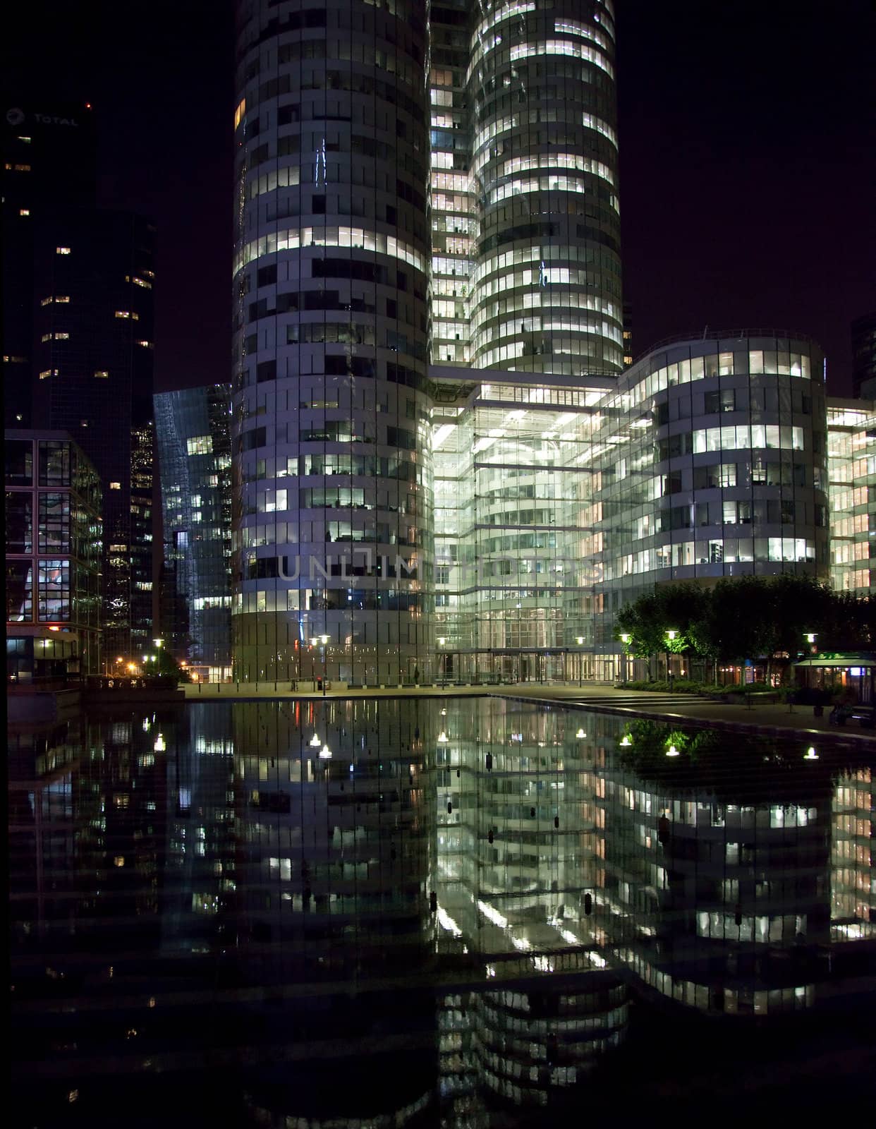 Modern skycraper office buildings reflected at night at La Defense in Paris