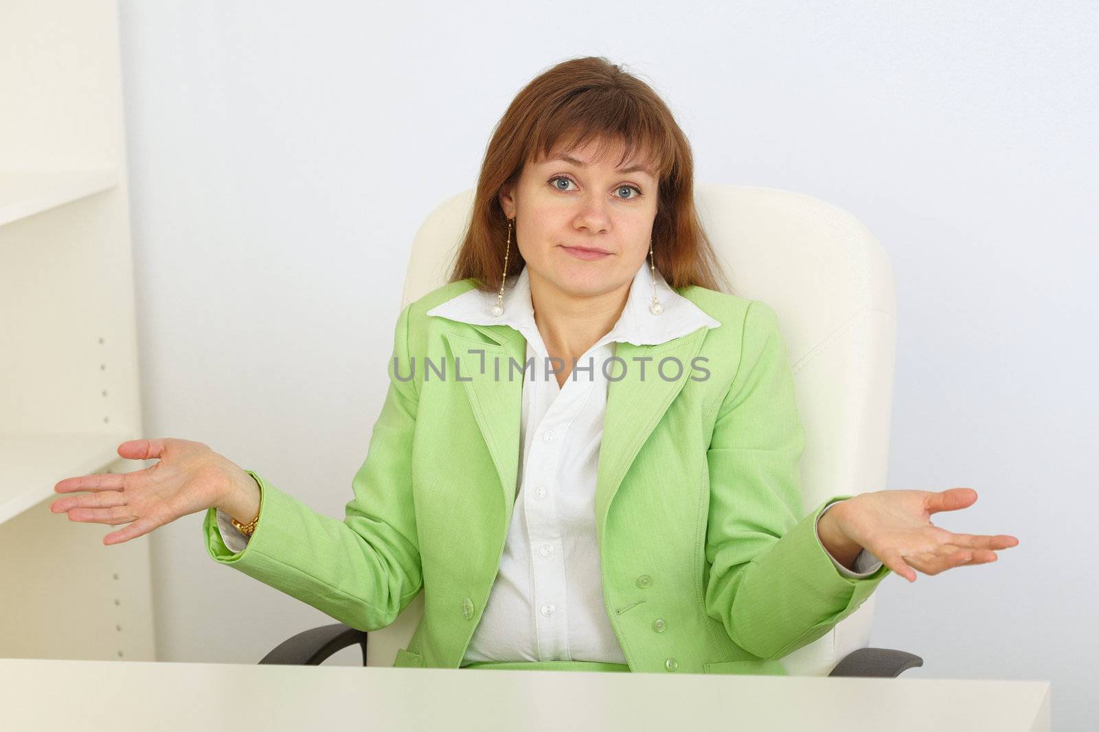 Young business woman with astonishment shrugs shoulders by pzaxe