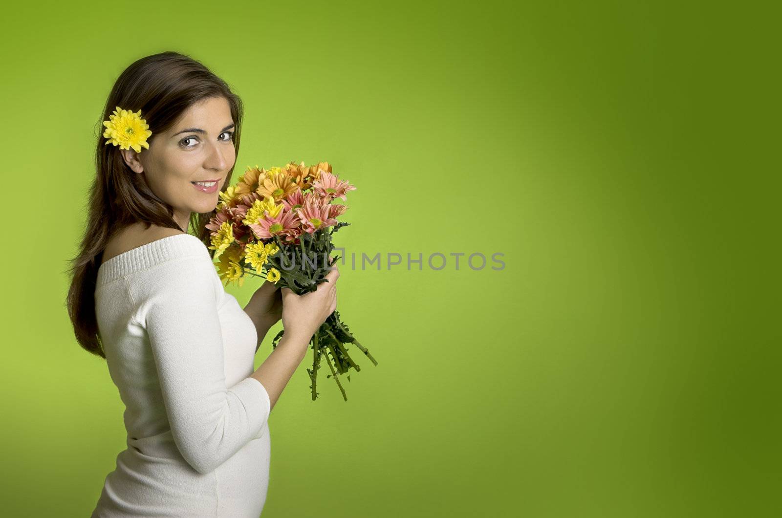 Beautiful woman with flowers on a green background