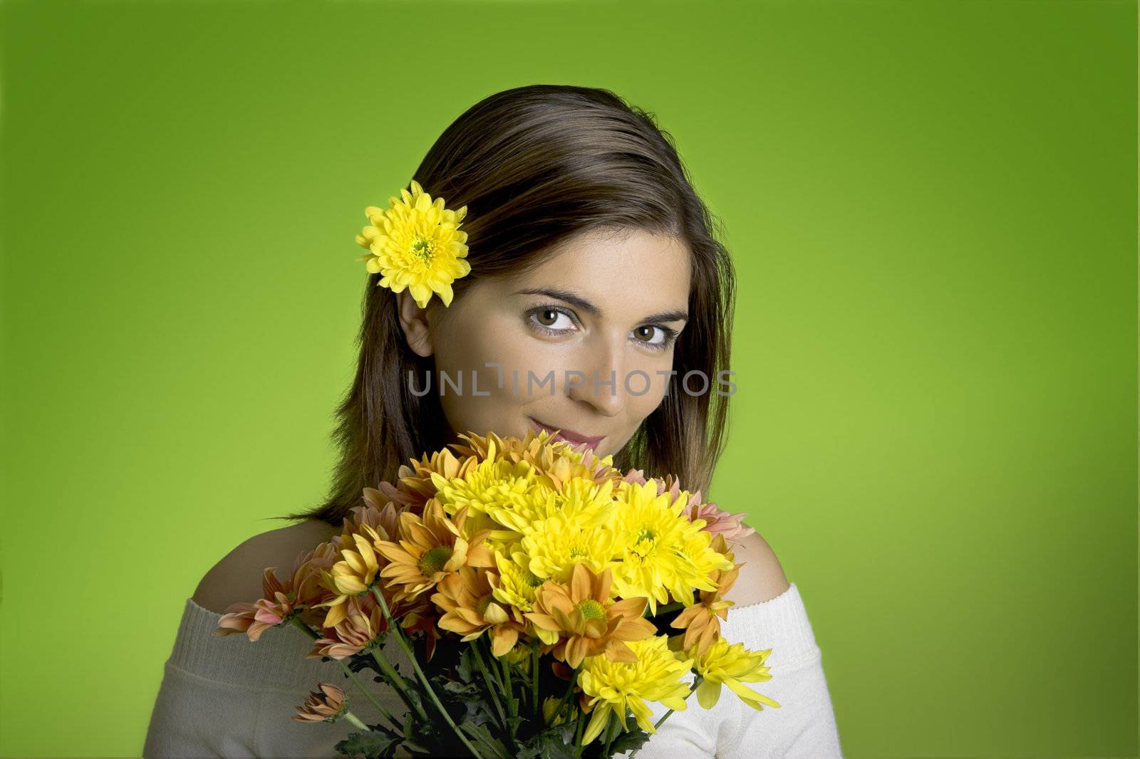 Beautiful woman with flowers on a green background