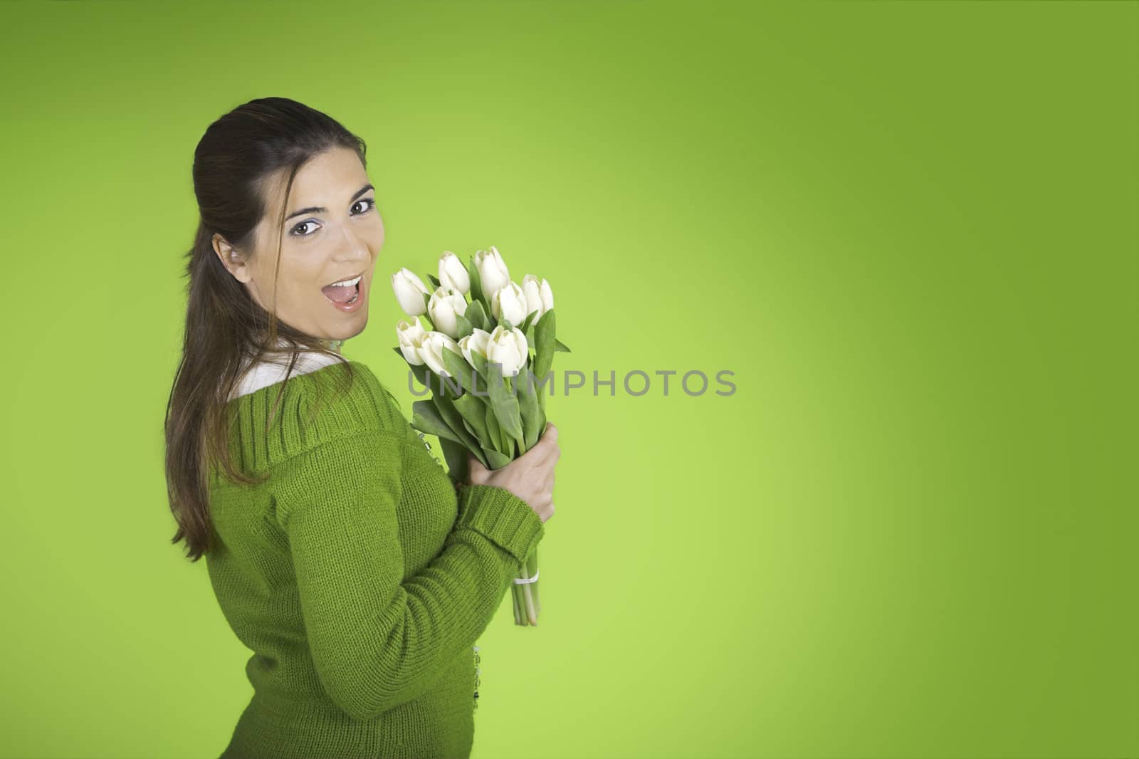 Beautiful woman with tulips on a green background