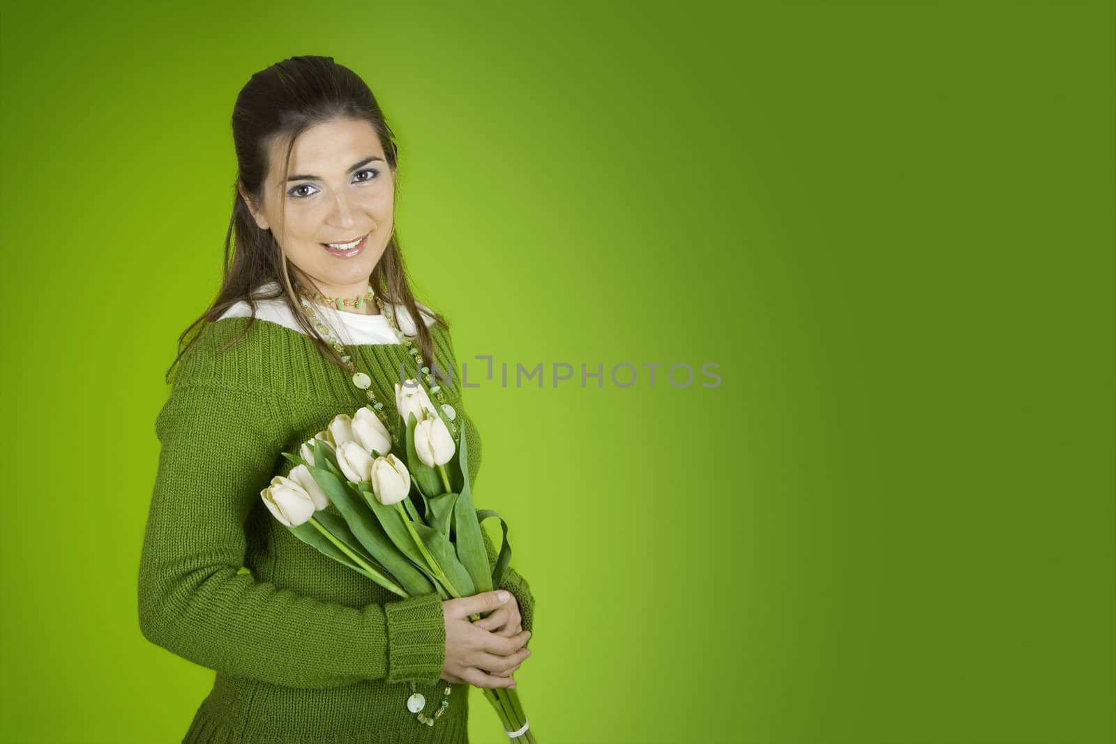 Beautiful woman with tulips on a green background