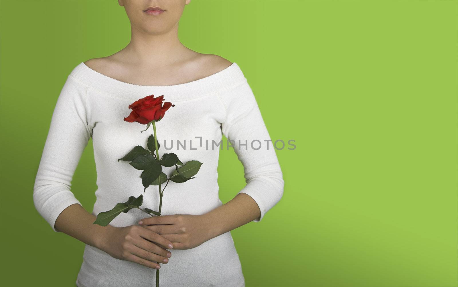 Woman with a red rose on is hands on a green background