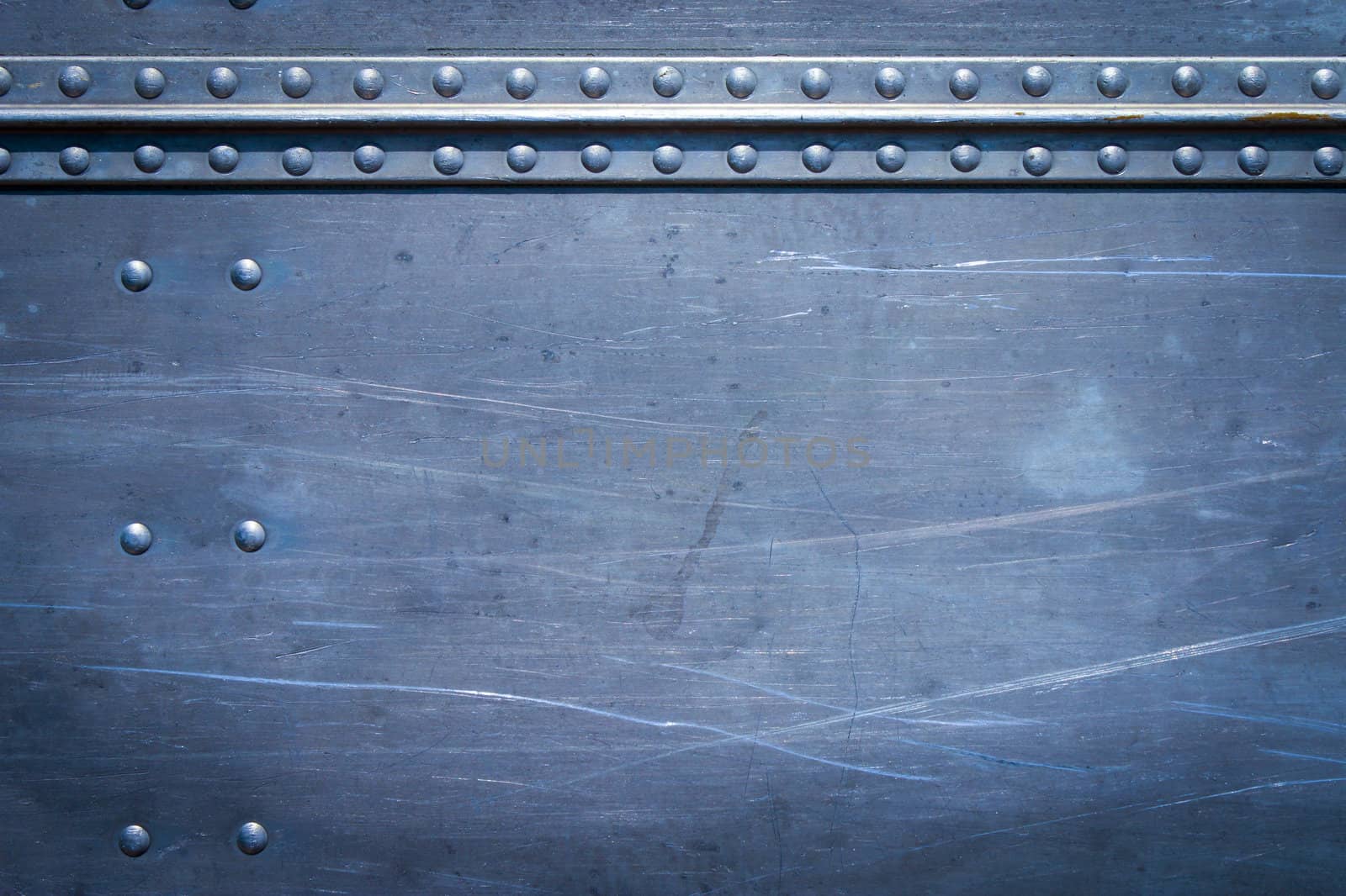 Rivets on scratched metal with seams