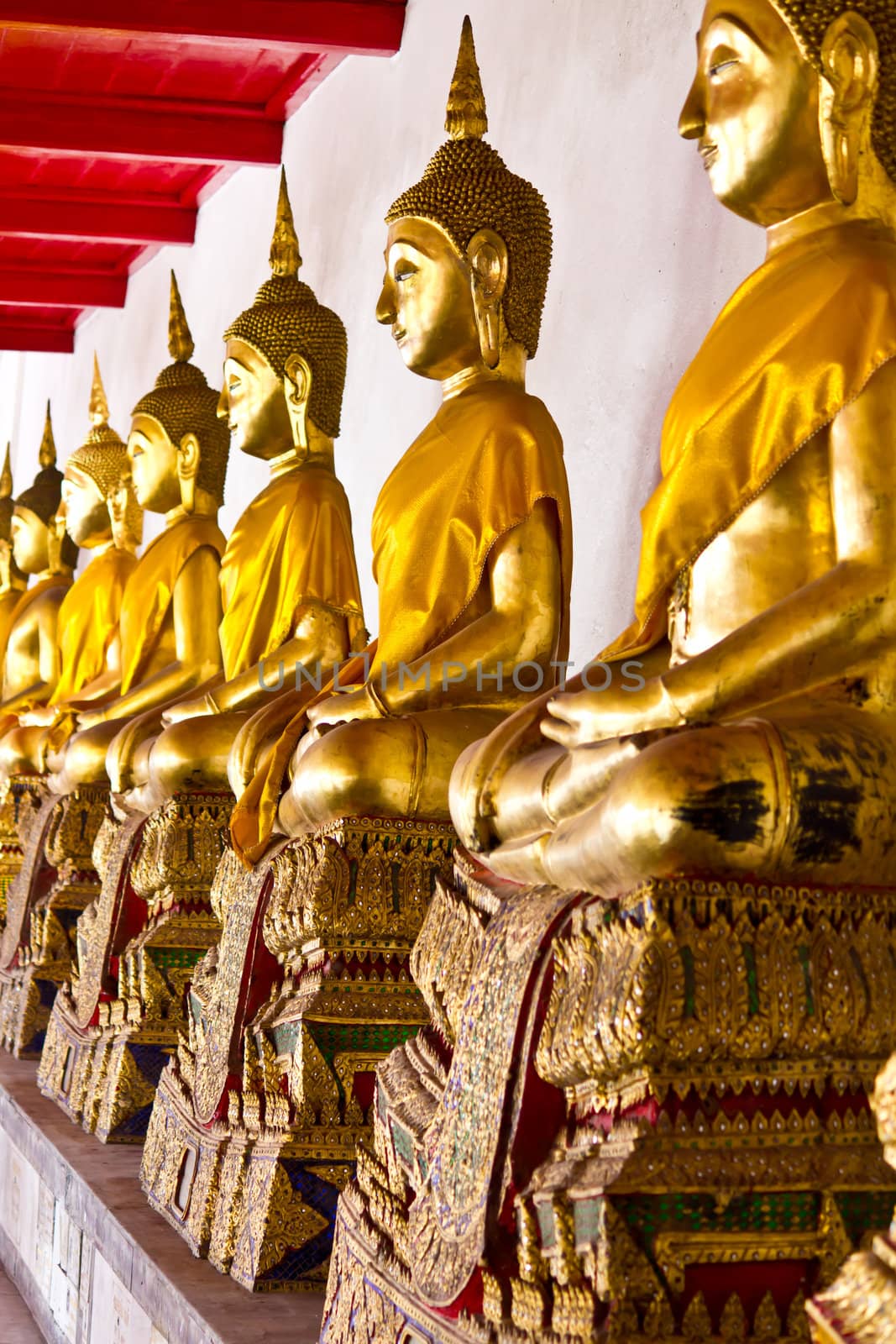 Golden sitting Buddha statues in Wat Mahathat Bangkok Thailand