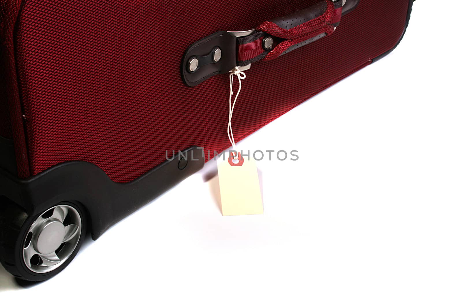 Red big suitcase with label for travel.