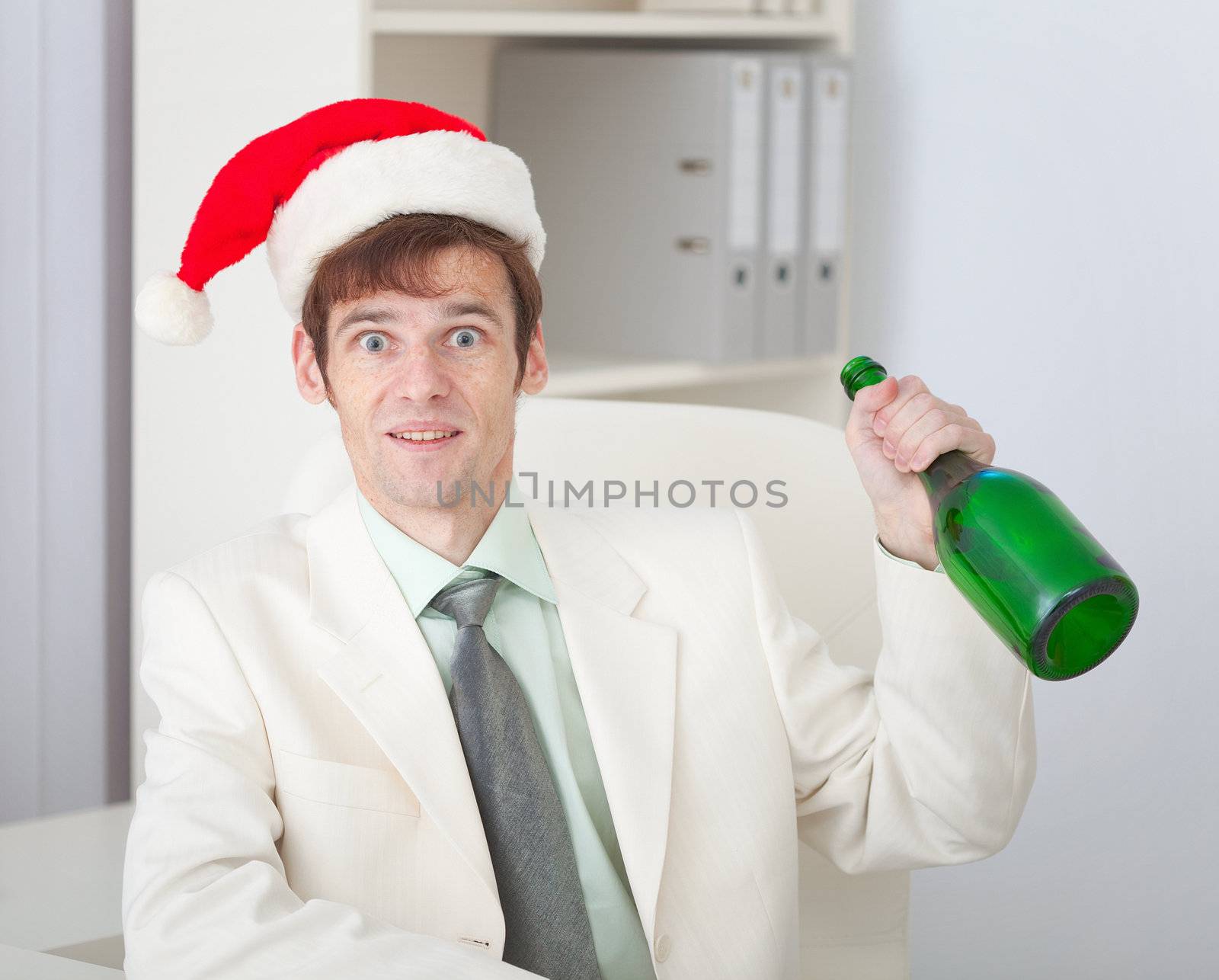 The businessman cheerfully celebrates Christmas at office