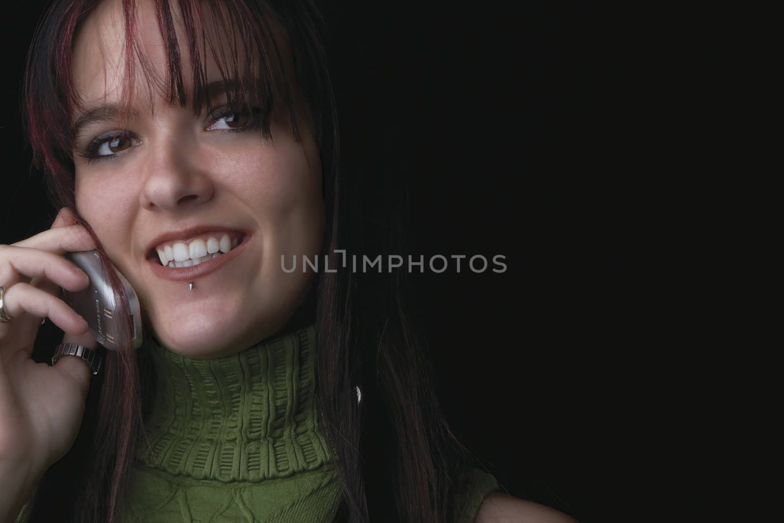 Close up portrait of a twenty something fashion model smiling with a cell phone in hand