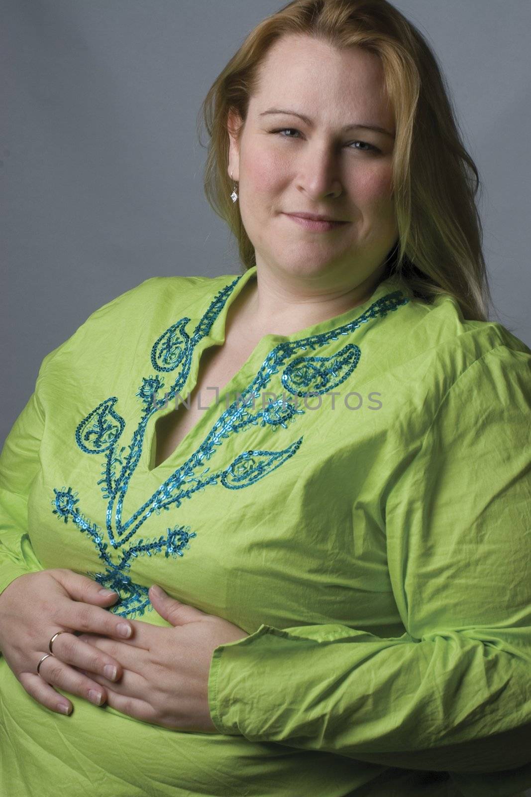 Female model in her thirties, over weight, with green top