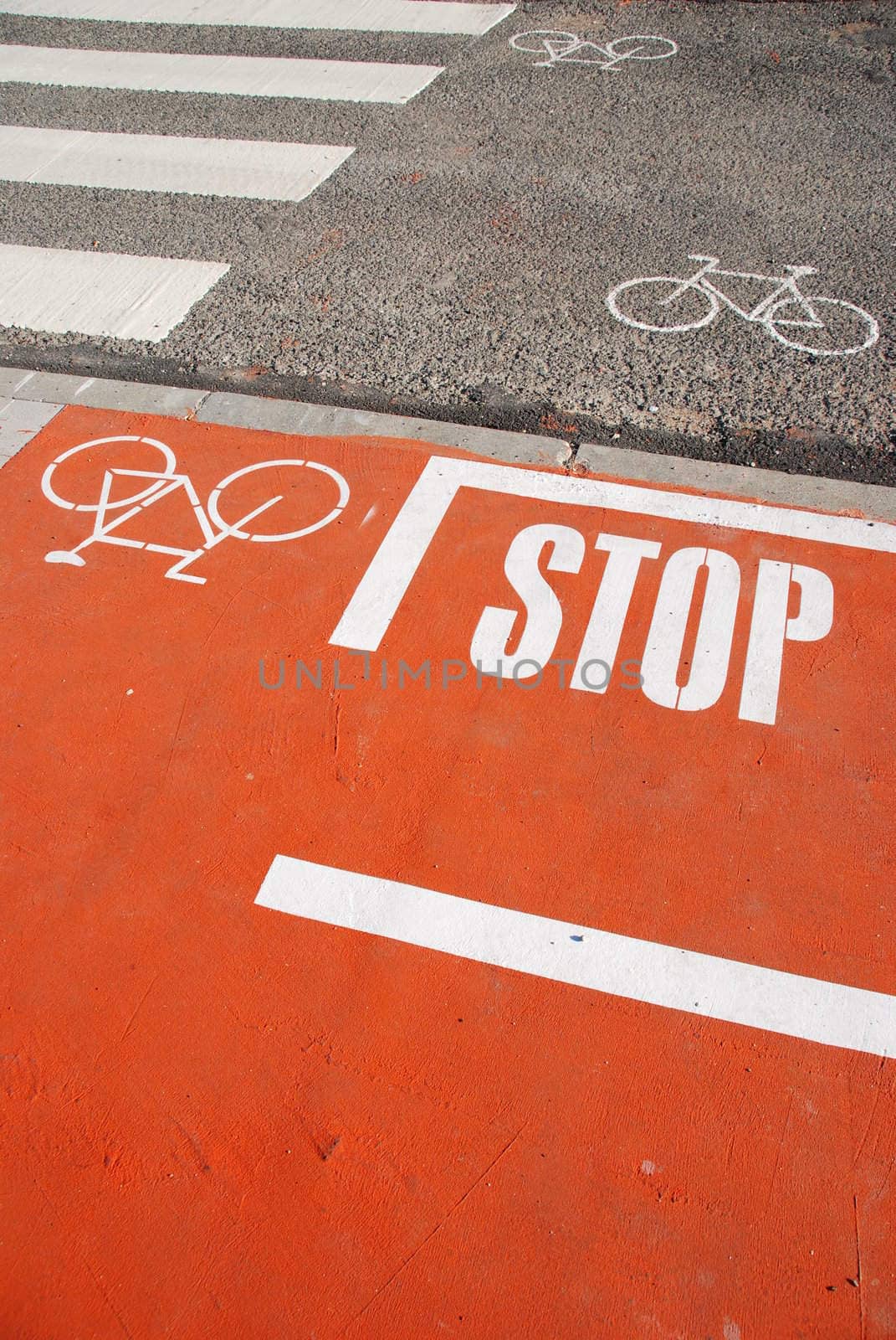 Orange bicycle lane with a STOP sign by luissantos84