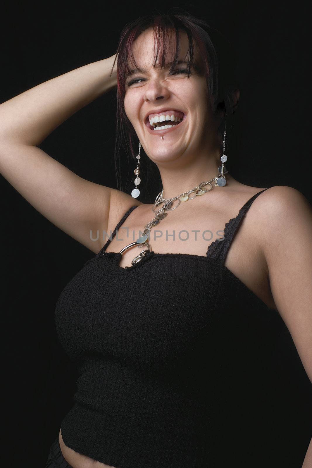 Twenty something fashion model in full hearted laugh while posing