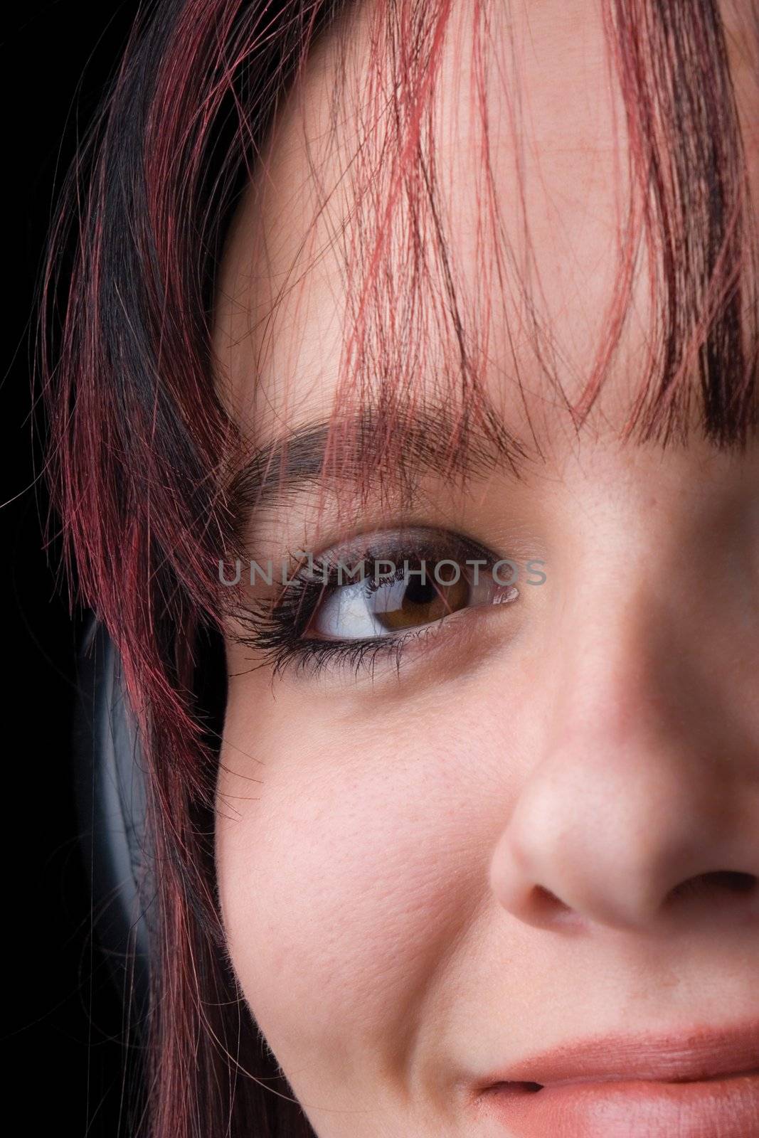 Close up of twenty something fashion model listening to music with big headphone