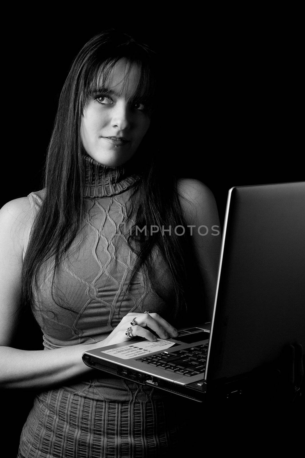 Twenty something fashion working on laptop standing