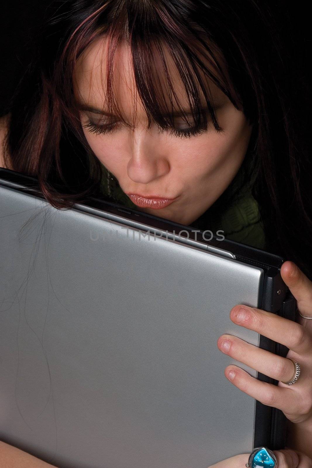 Twenty something fashion kissing her laptop