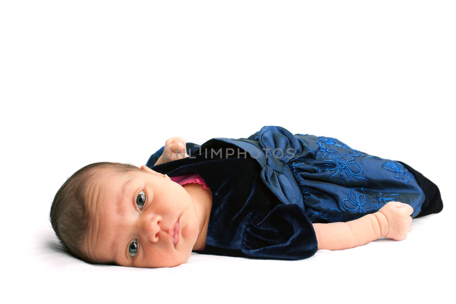A cute newborn baby infant isolated on a white backdrop.