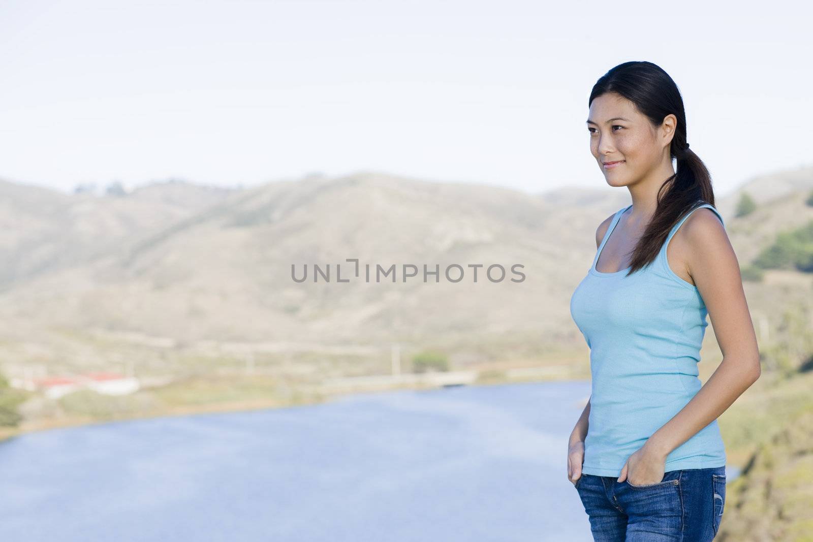 Smiling Young Asian Woman Standing in the Countryside