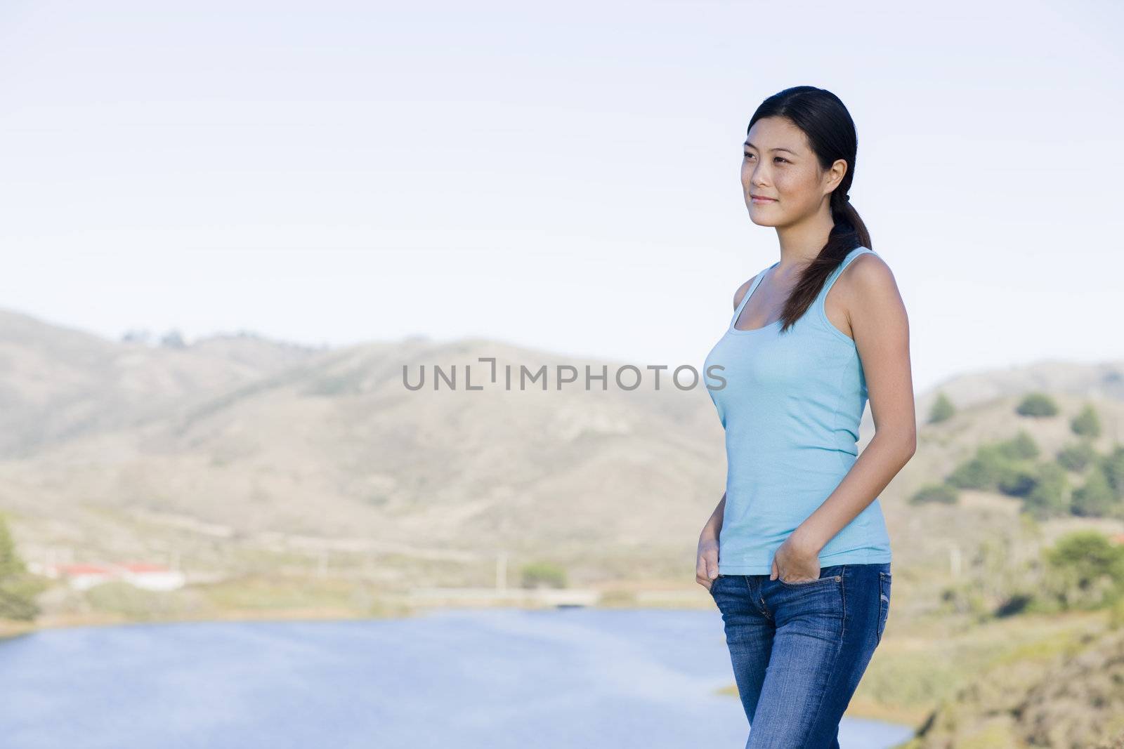Smiling Young Asian Woman Standing in the Countryside