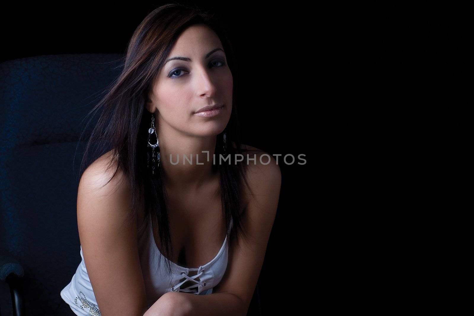 Twenty something fashion model sitting on office chair looking very calm attitude