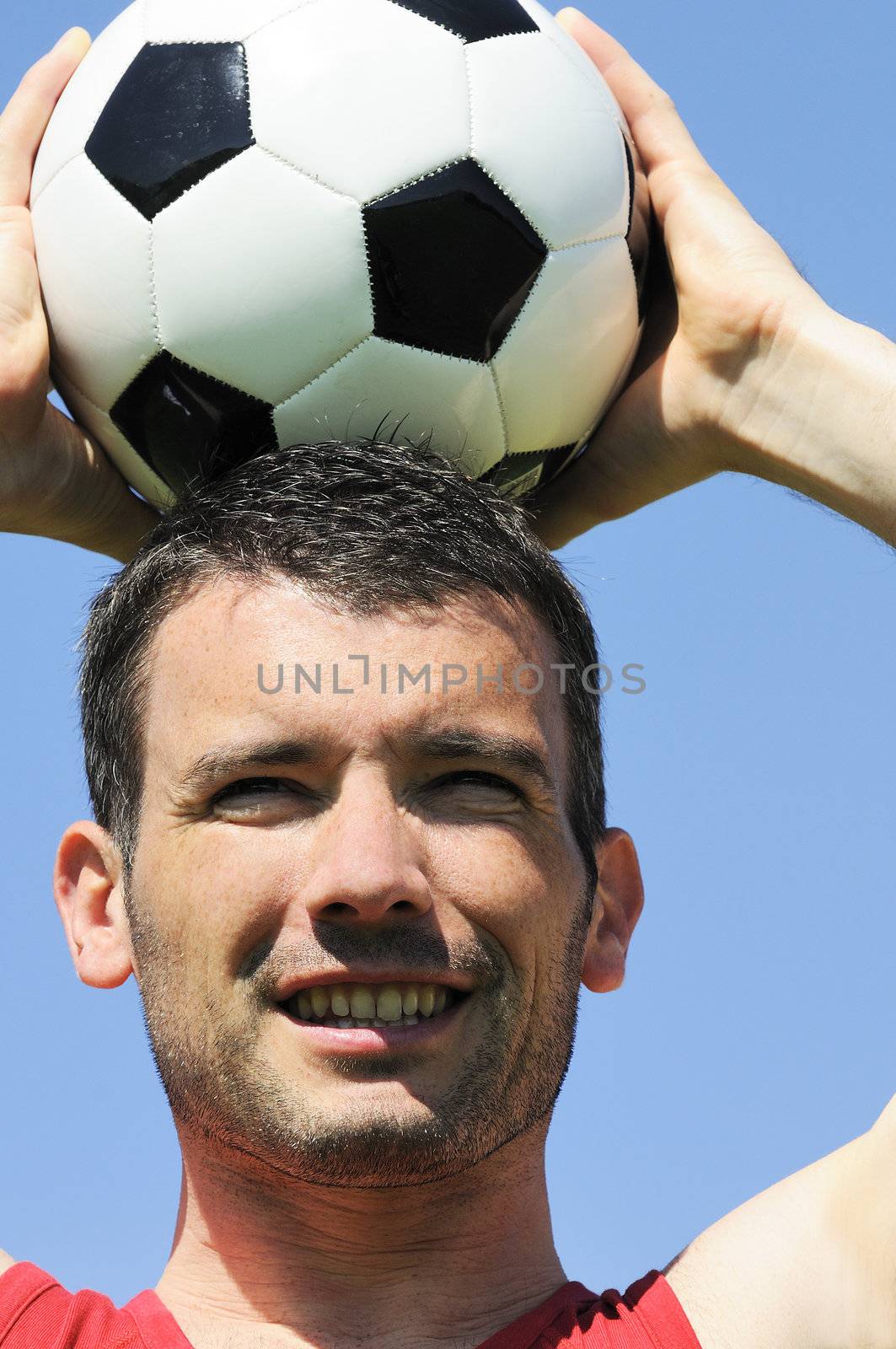 attractive football player with black and white balloon
