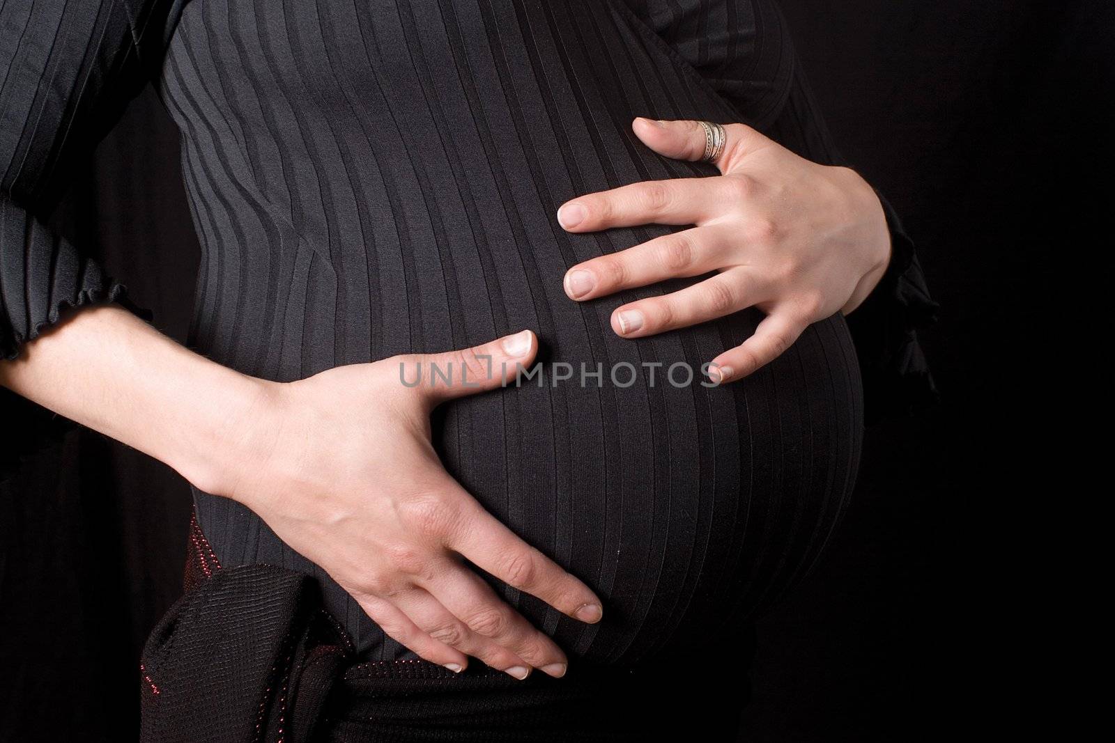 Close of a pregnant belly being hold 