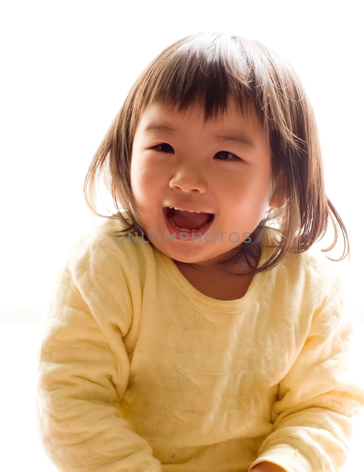 There is a happy Asian girl with smile in white background.
