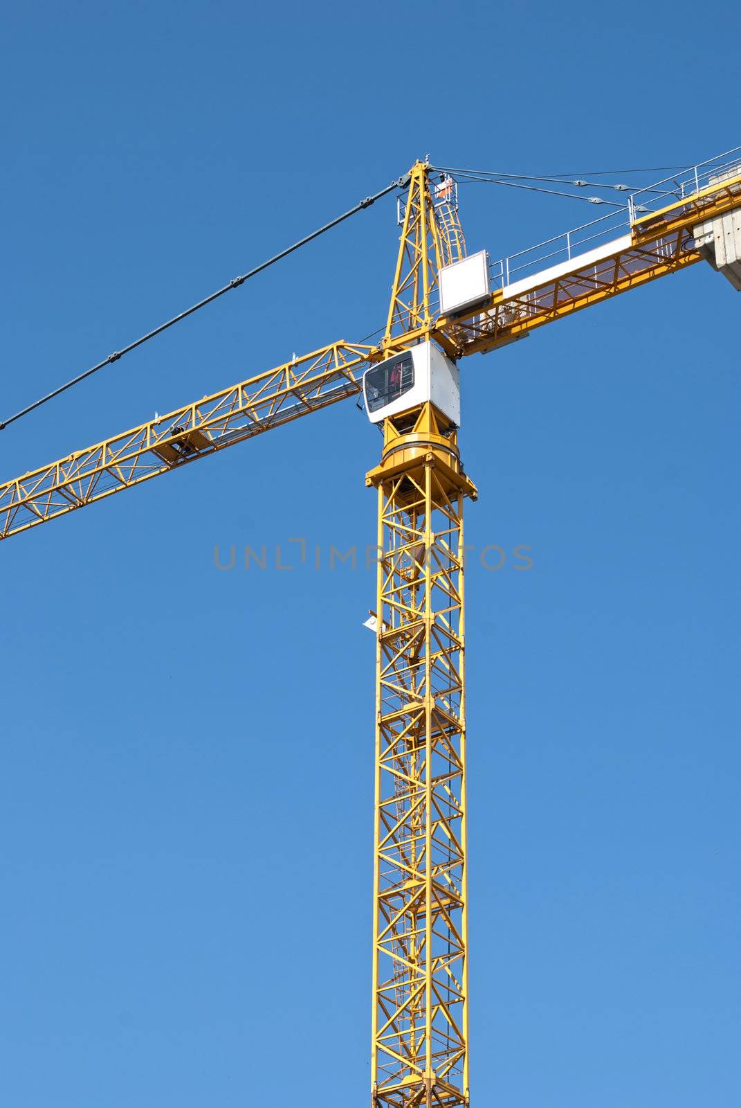 Yellow crane on blue sky background