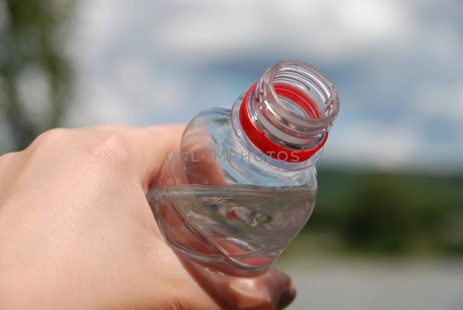 Human hand holding a bottle of water
