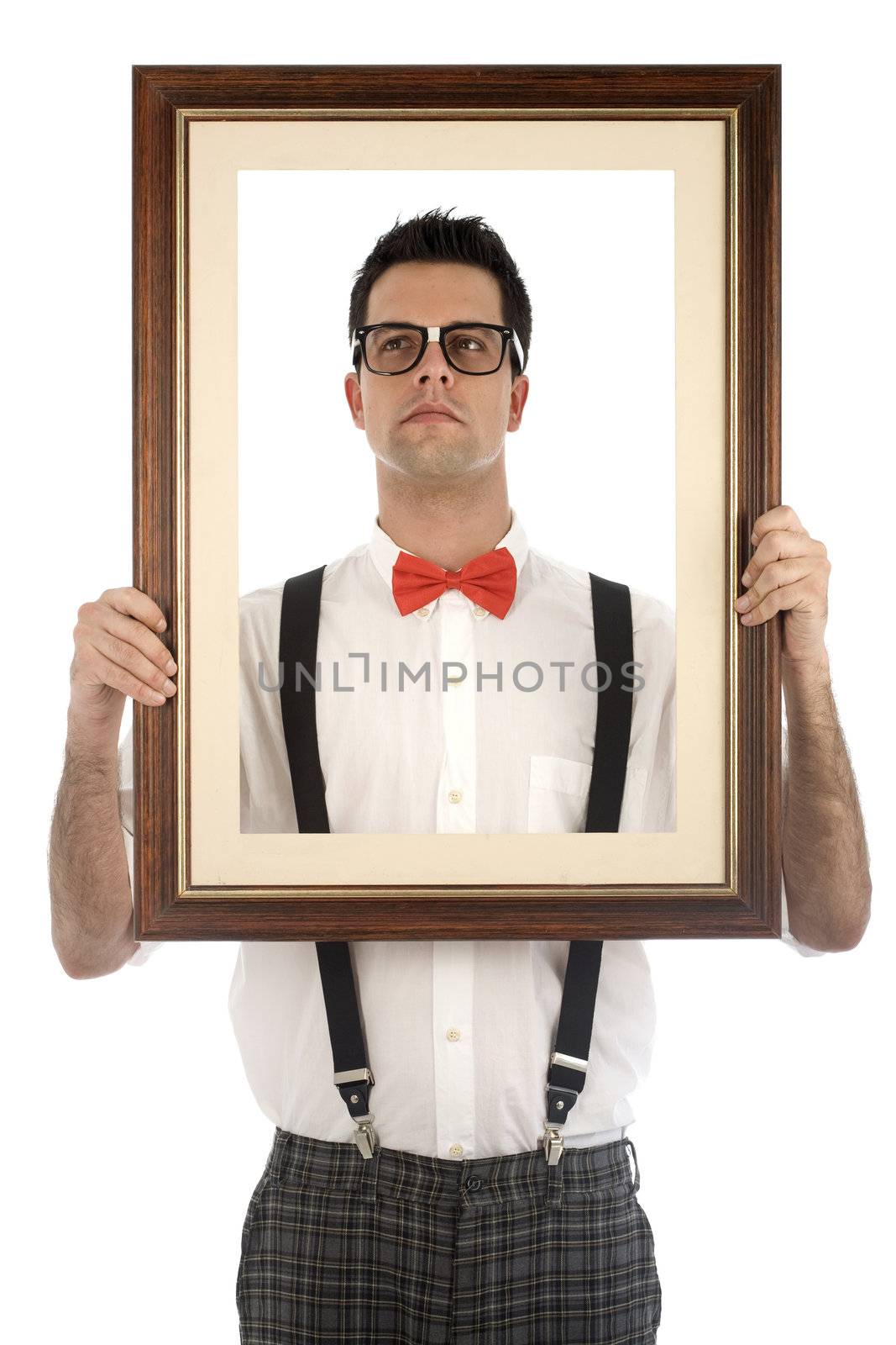 A young, caucasian nerd, holding up a frame, isolated on a white background.