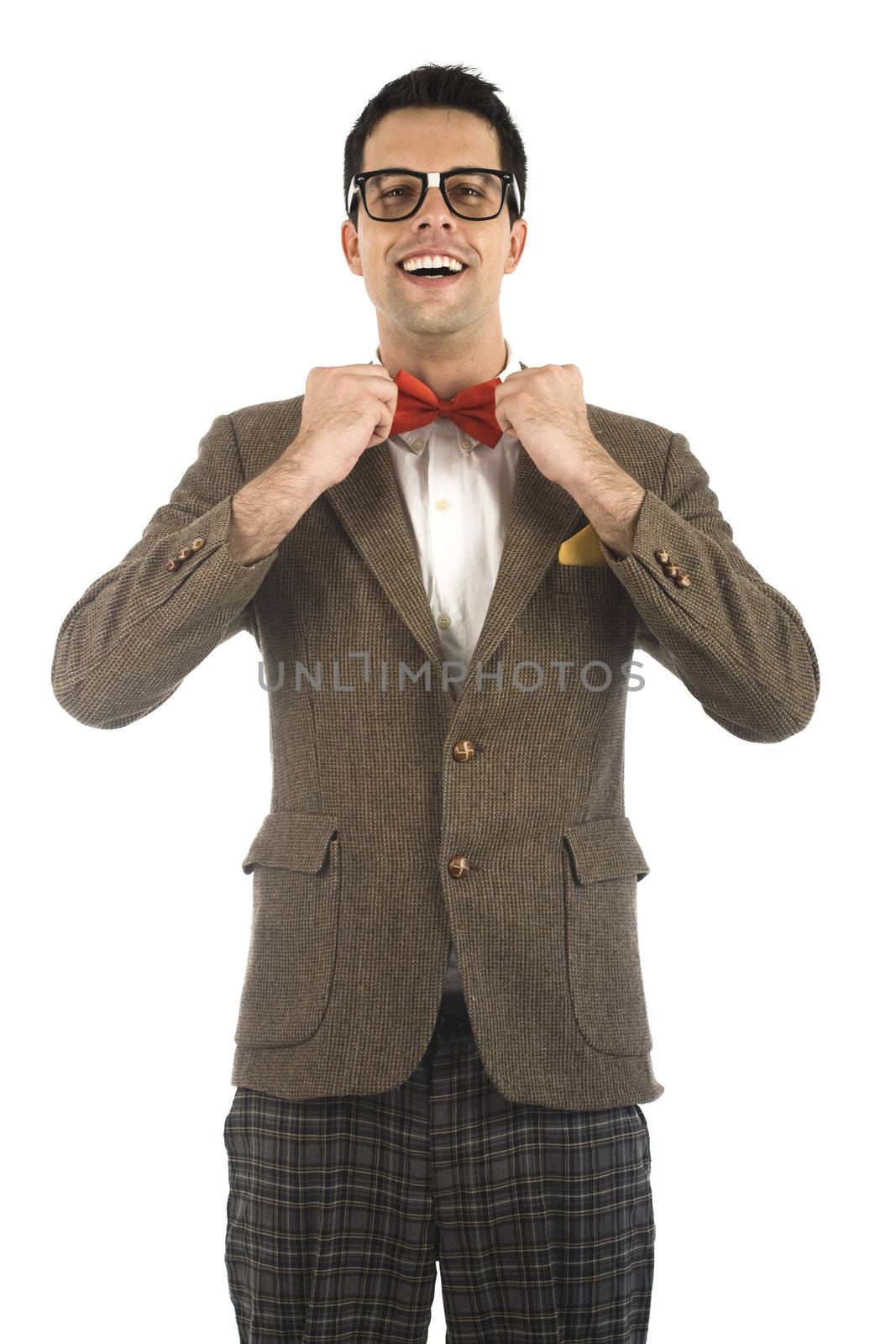 A young, caucasian nerd ajusting his bow-tie, isolated on a white background.