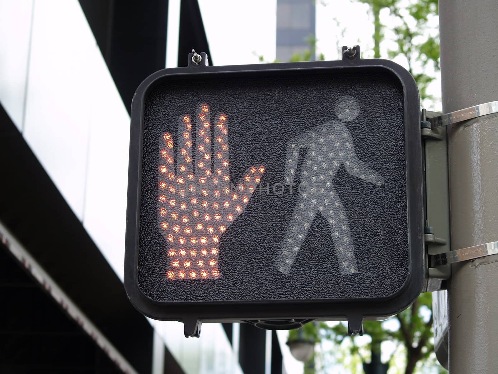 Modern crossing sign with stop hand showing.