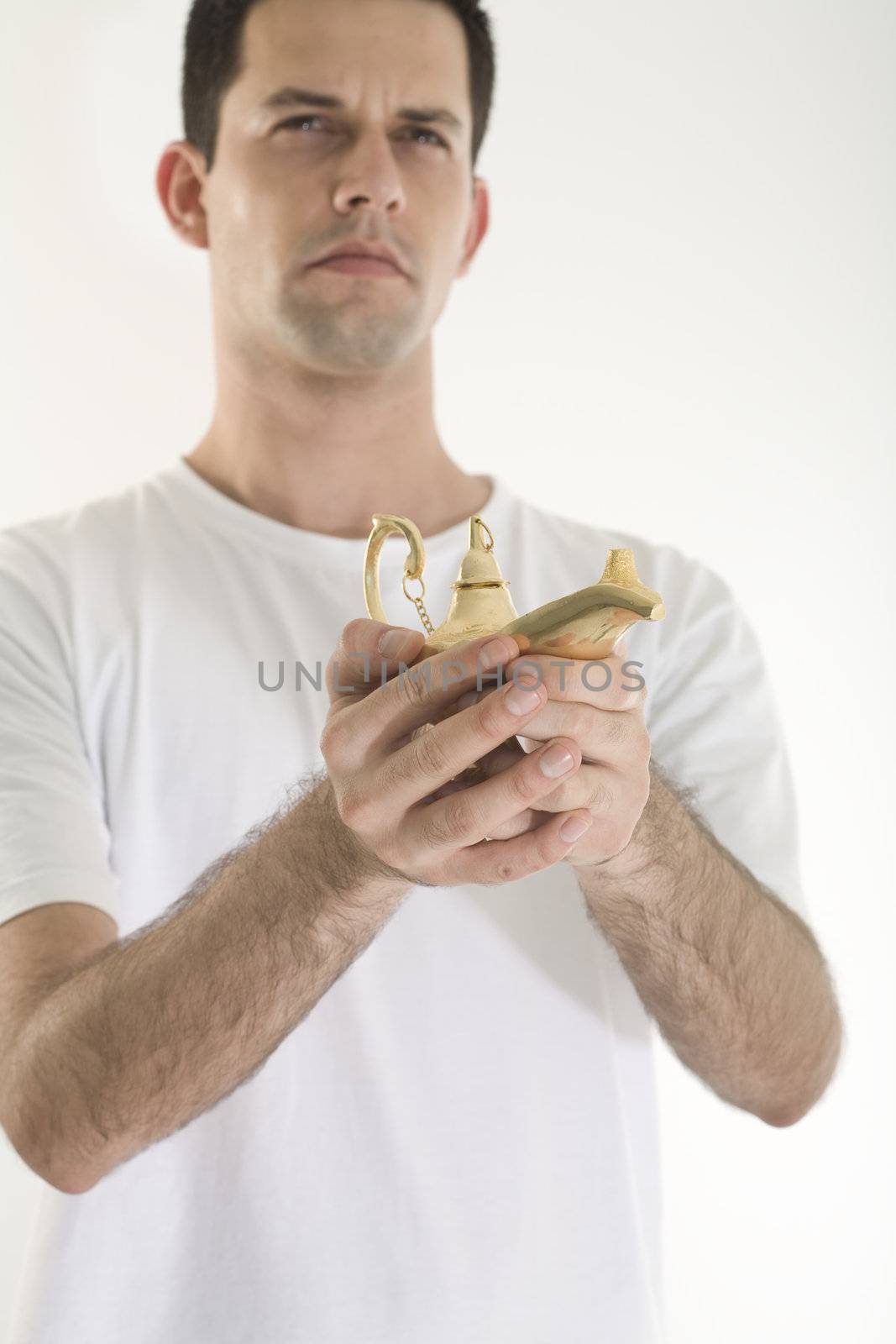 A young, caucasian male, holding a golden magic lamp.