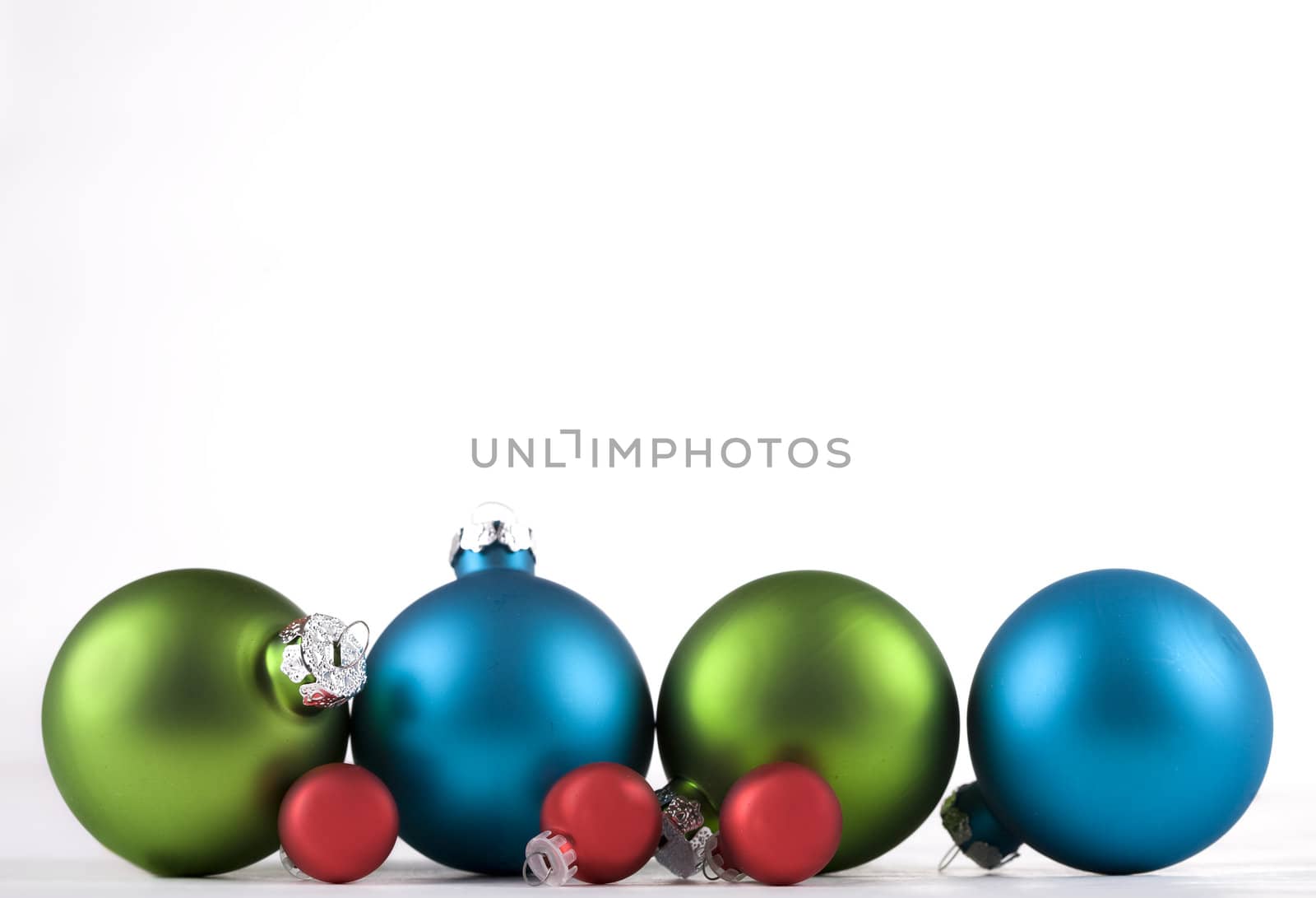 Blue and green, and red, Christmas ornaments lined up, isolated