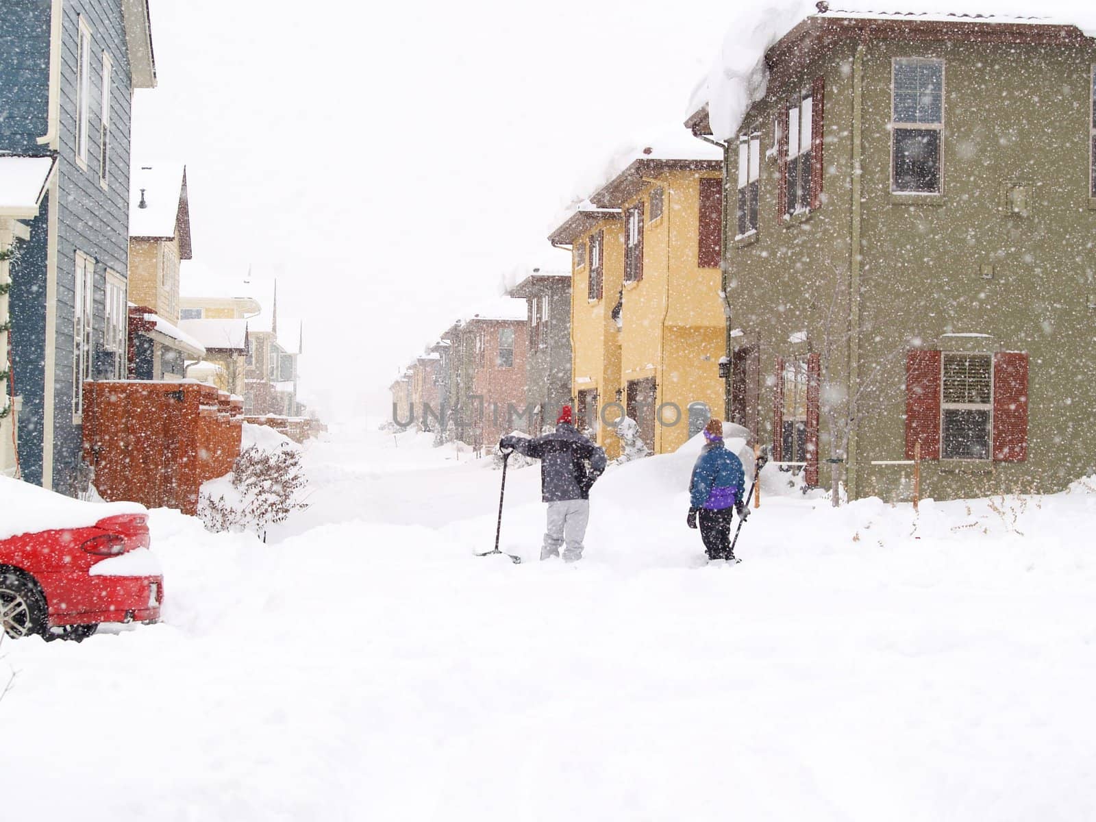 People taking a break from shoveling a great deal of snow.