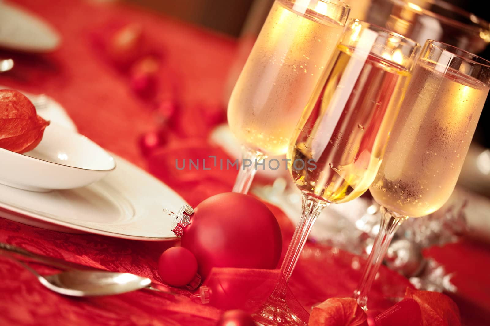 Elegant Christmas table setting in red with a Christmas ornament  as focal point